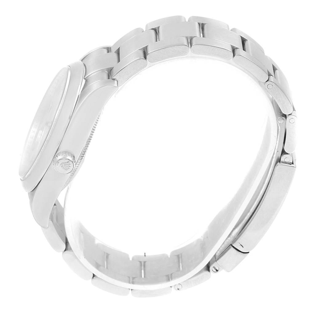 This image shows the Rolex Air-King 114200 Stainless Steel Silver Dial 114200 Stainless Steel Silver Dial watch from a side angle, highlighting the case, bracelet, and clasp.