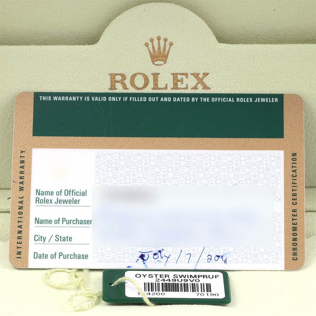 The image shows the warranty card and swing tag for a Rolex Air-King 114200 Stainless Steel Silver Dial 114200 Stainless Steel Silver Dial watch, taken from a directly overhead angle.