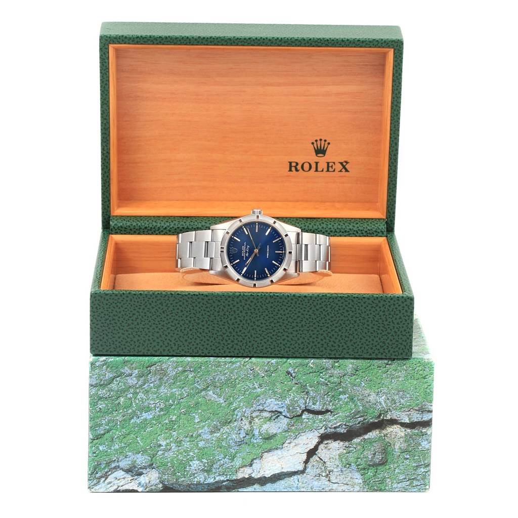 The Rolex Air-King 14010 Men's Stainless Steel Blue Dial 14010 Men's Stainless Steel Blue Dial watch is displayed front-on in an open green and wooden Rolex box.
