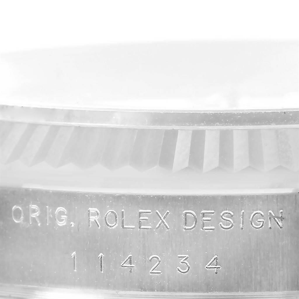 This image shows a close-up of the case side of a Rolex Air-King 114234 Stainless Steel Silver Dial 114234 Stainless Steel Silver Dial watch, displaying the engraving "ORIG. ROLEX DESIGN" and model number 114234.