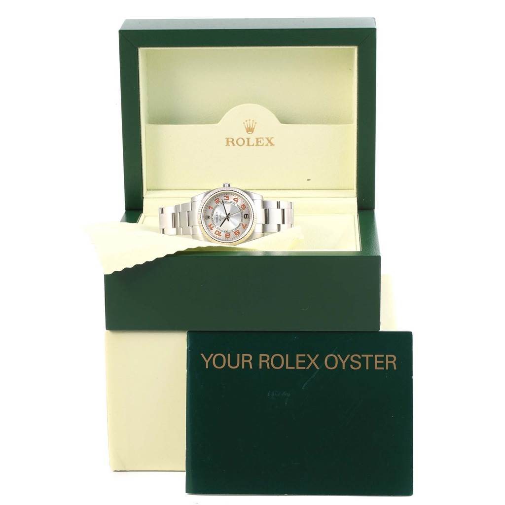 The Rolex Air-King 114234 Stainless Steel Silver Dial 114234 Stainless Steel Silver Dial watch is displayed from the front in its open box, showing the face and bracelet, with the warranty card below.