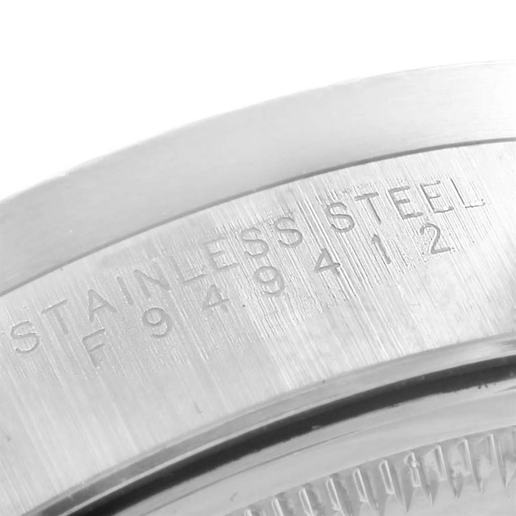 This image shows a close-up of the case back edge of a Rolex Air-King 14010 Men's Stainless Steel Pink Dial 14010 Men's Stainless Steel Pink Dial watch, highlighting the "Stainless Steel" engraving.
