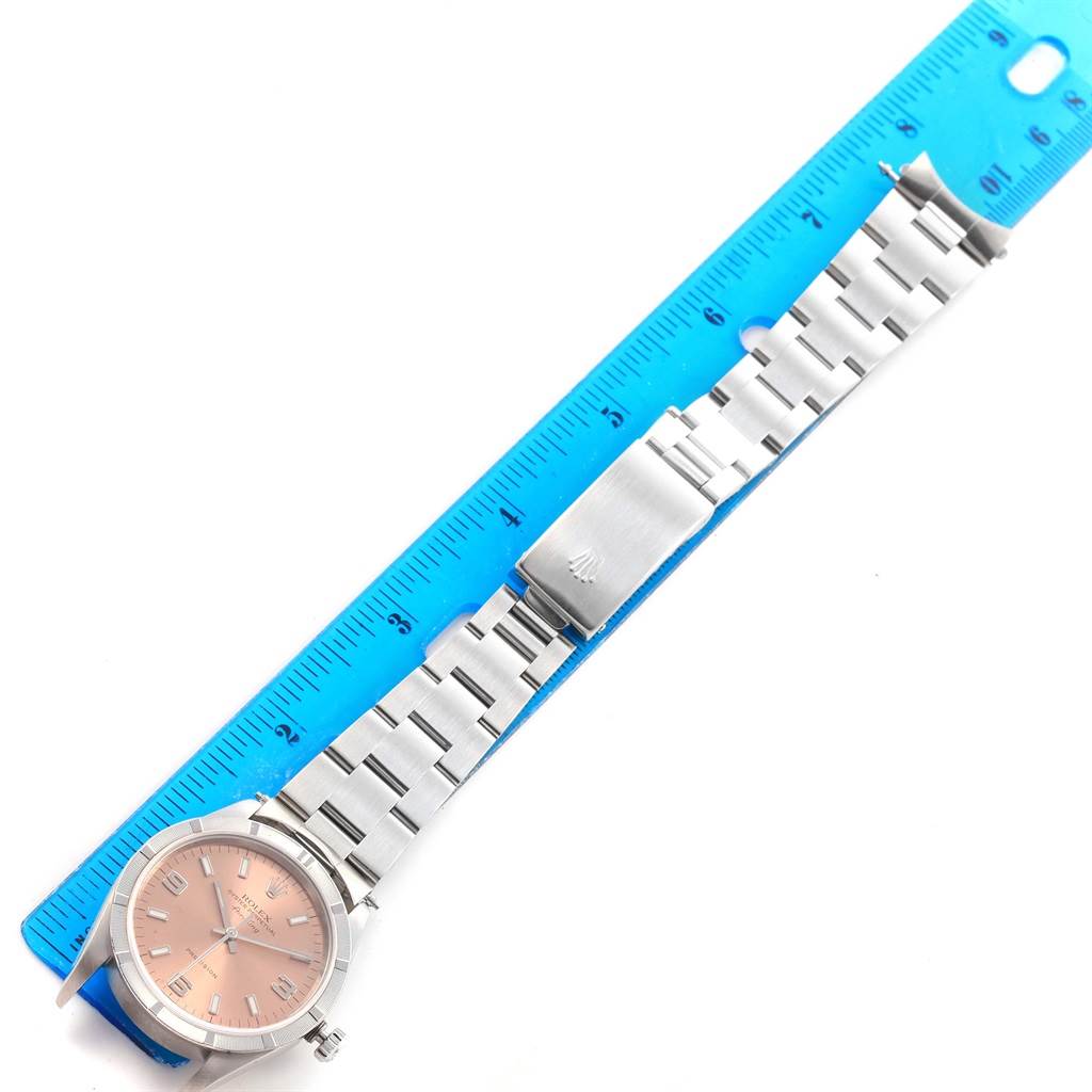 The image shows a Rolex Air-King 14010 Men's Stainless Steel Pink Dial 14010 Men's Stainless Steel Pink Dial watch and its metal bracelet laid flat next to a blue ruler.