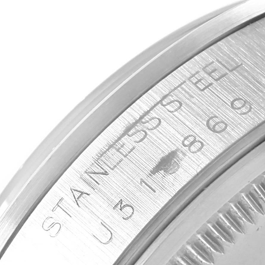 This close-up image shows the side of the bezel and part of the engraved serial number on the Rolex Air-King 14000 Men's Stainless Steel Silver Dial 14000 Men's Stainless Steel Silver Dial watch.