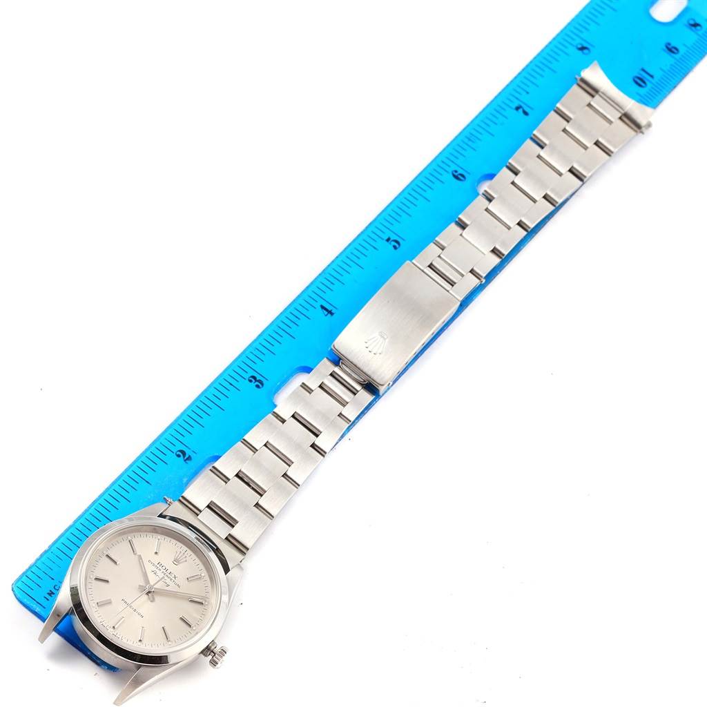 The image shows a Rolex Air-King 14000 Men's Stainless Steel Silver Dial 14000 Men's Stainless Steel Silver Dial watch laid flat next to a blue ruler, displaying the face and metal bracelet.