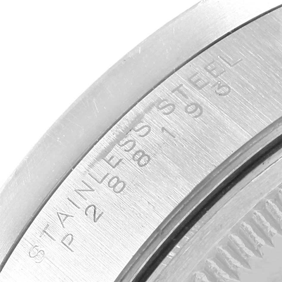 This image shows a close-up of the engraved serial numbers on the case back of a Rolex Air-King 14010 Men's Stainless Steel Black Dial 14010 Men's Stainless Steel Black Dial watch.