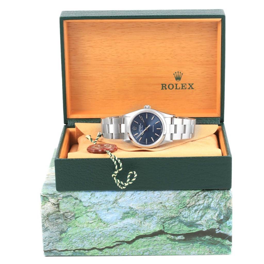 The Rolex Air-King 14000 Men's Stainless Steel Blue Dial 14000 Men's Stainless Steel Blue Dial watch is displayed in an open green and wooden Rolex box, showing the watch's face and bracelet.
