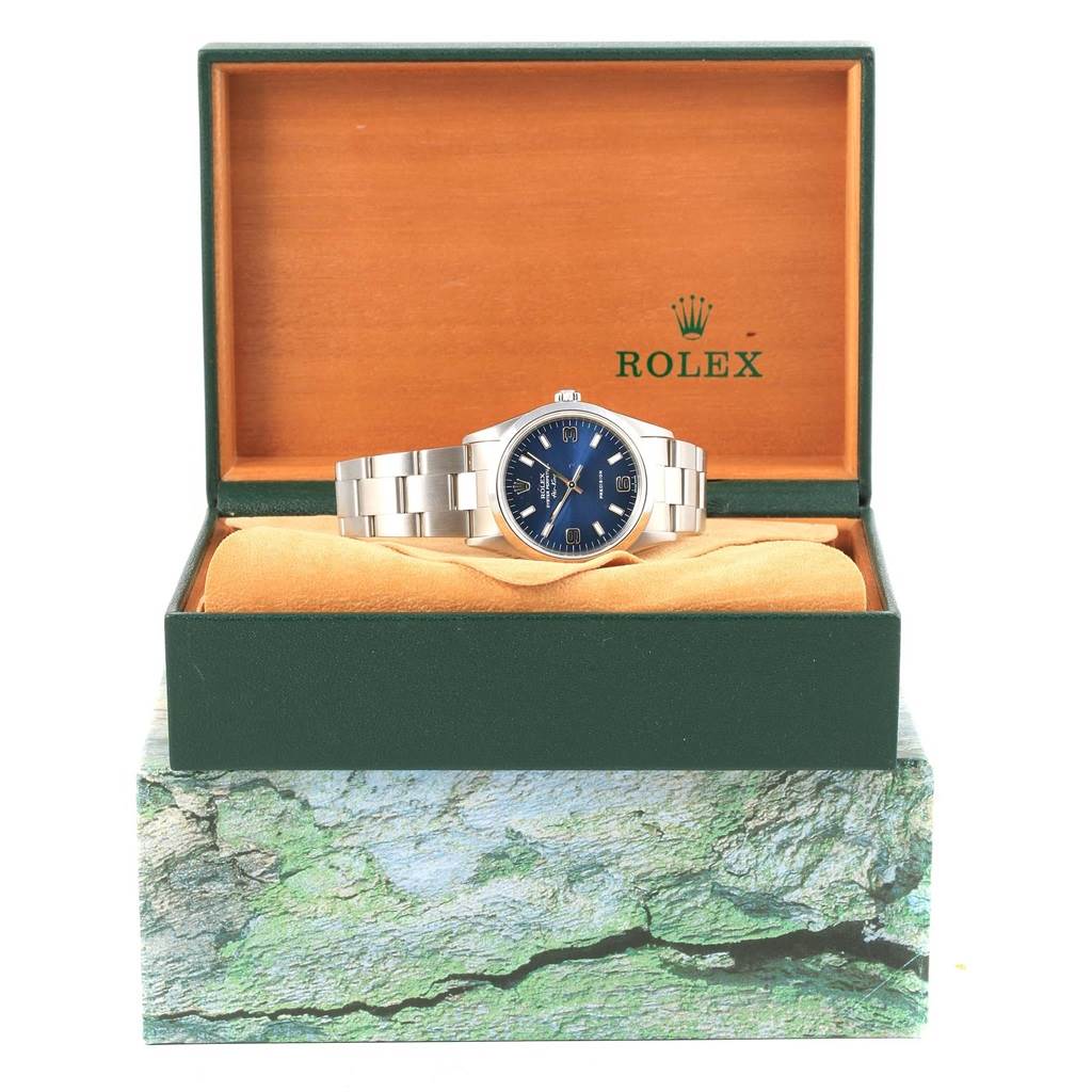 The Rolex Air-King 14000 Men's Stainless Steel Blue Dial 14000 Men's Stainless Steel Blue Dial watch is shown from the front, placed on a cushion inside an open green and wooden display box.