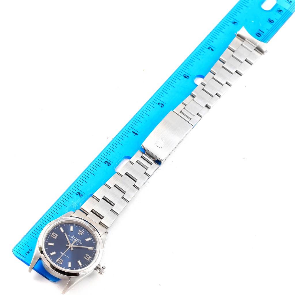 The image shows a Rolex Air-King 14000 Men's Stainless Steel Blue Dial 14000 Men's Stainless Steel Blue Dial watch laid flat alongside a blue ruler.