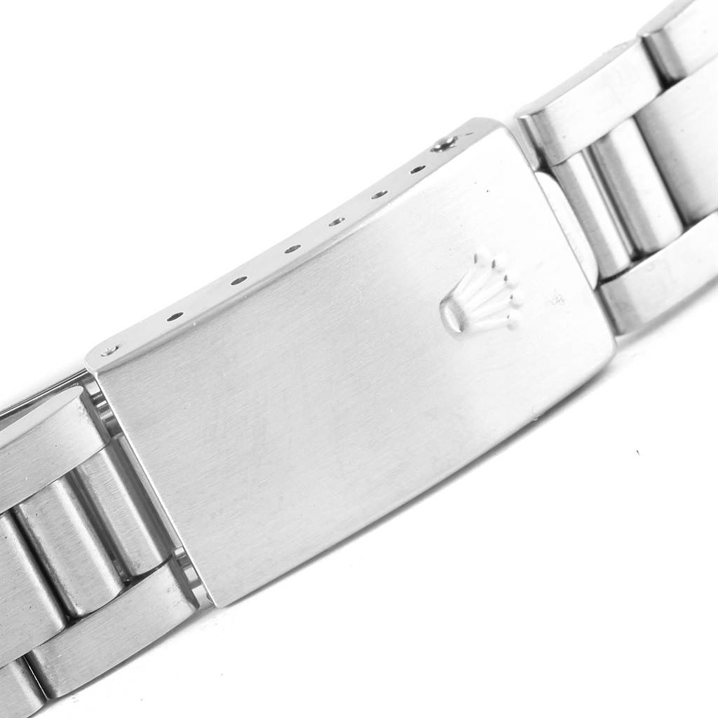 The image shows a close-up of the clasp of a Rolex Air-King 14010 Men's Stainless Steel Silver Dial 14010 Men's Stainless Steel Silver Dial watch, focusing on the detailed Rolex logo.