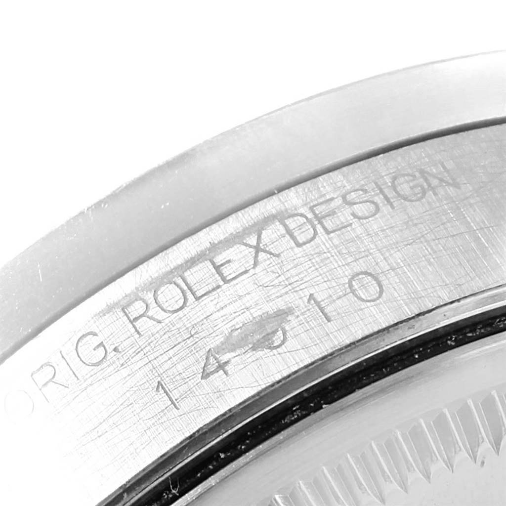 This image shows a close-up of the case back edge of a Rolex Air-King 14010 Men's Stainless Steel Silver Dial 14010 Men's Stainless Steel Silver Dial watch, focusing on the engraved model number and "ROLEX DESIGN" inscription.