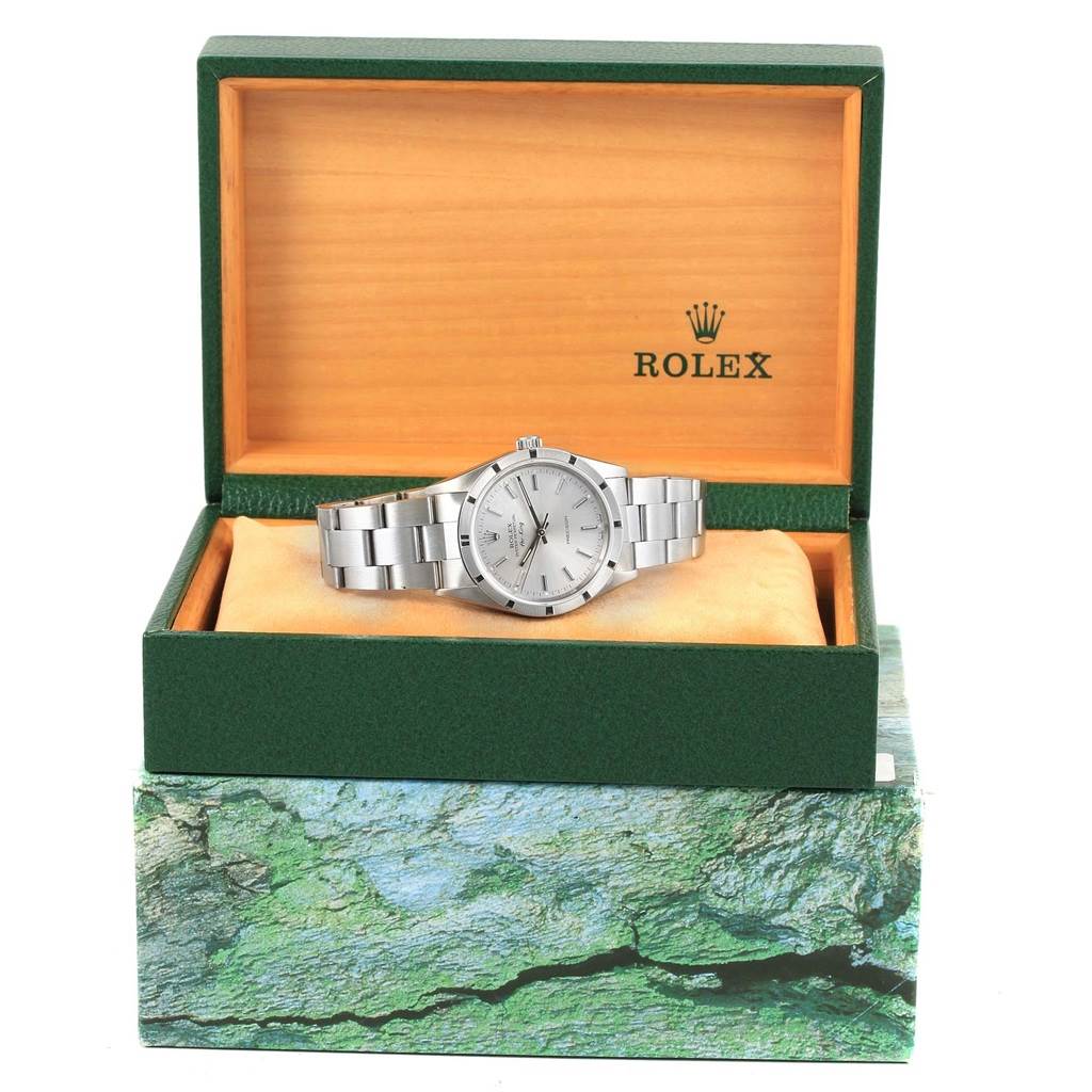 The Rolex Air-King 14010 Men's Stainless Steel Silver Dial 14010 Men's Stainless Steel Silver Dial watch is shown from a front angle in its open, green branded box.