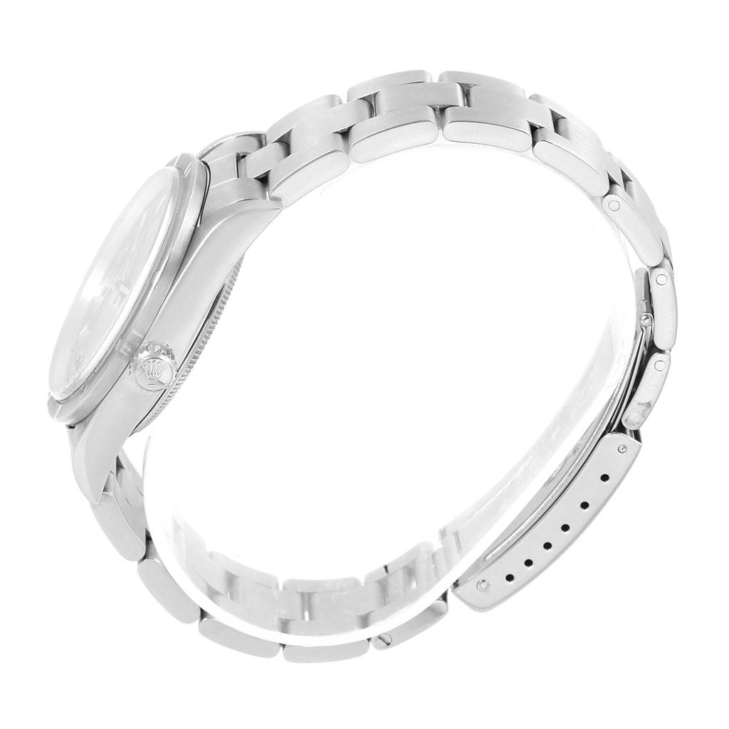 This side-view angle of the Rolex Air-King 14010 Stainless Steel Pink Dial 14010 Stainless Steel Pink Dial watch shows the case, crown, and the metal bracelet.