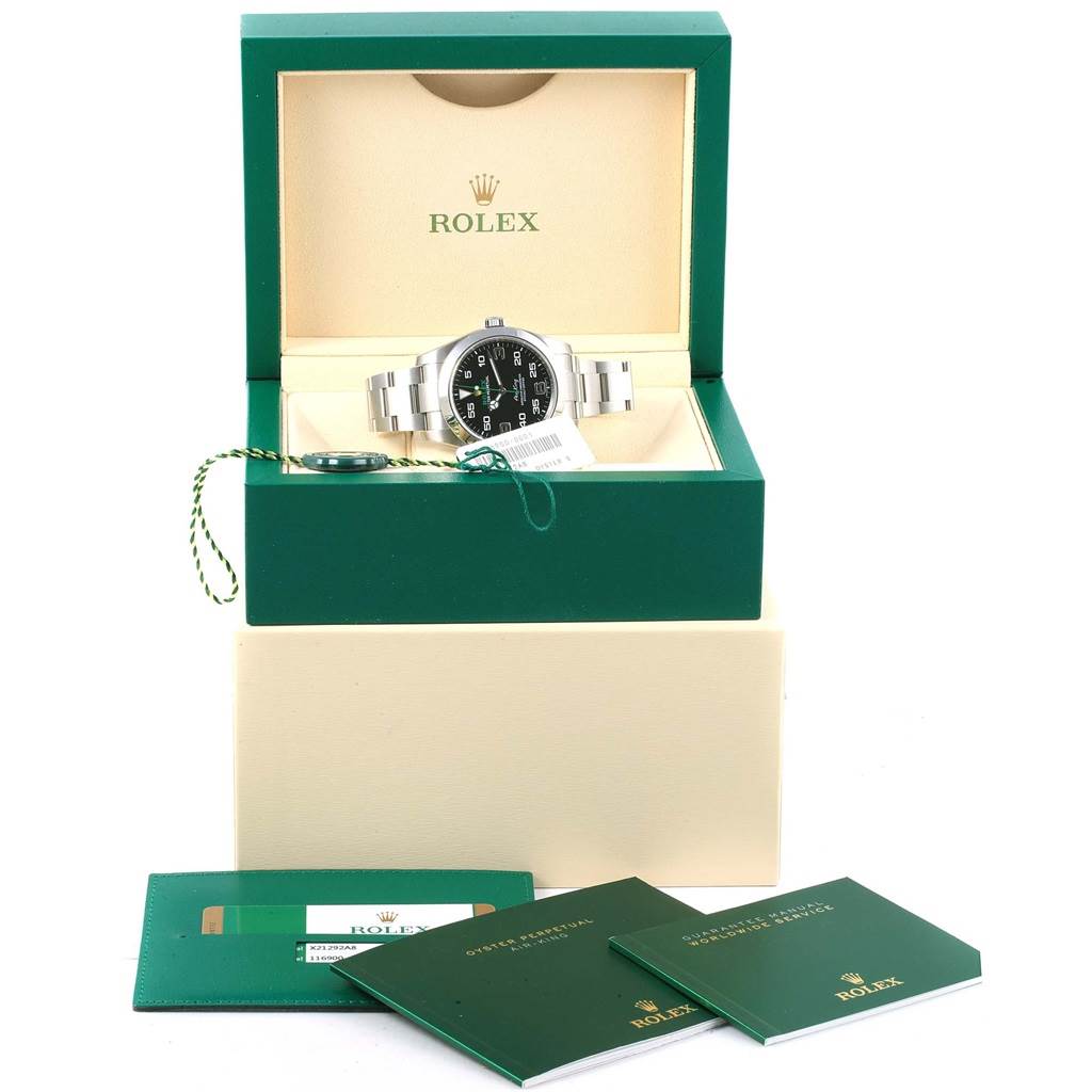 The Rolex Air-King 116900 Men's Stainless Steel Black Dial 116900 Men's Stainless Steel Black Dial watch is shown in its open box, with its manuals, tags, and accessories arranged around it.