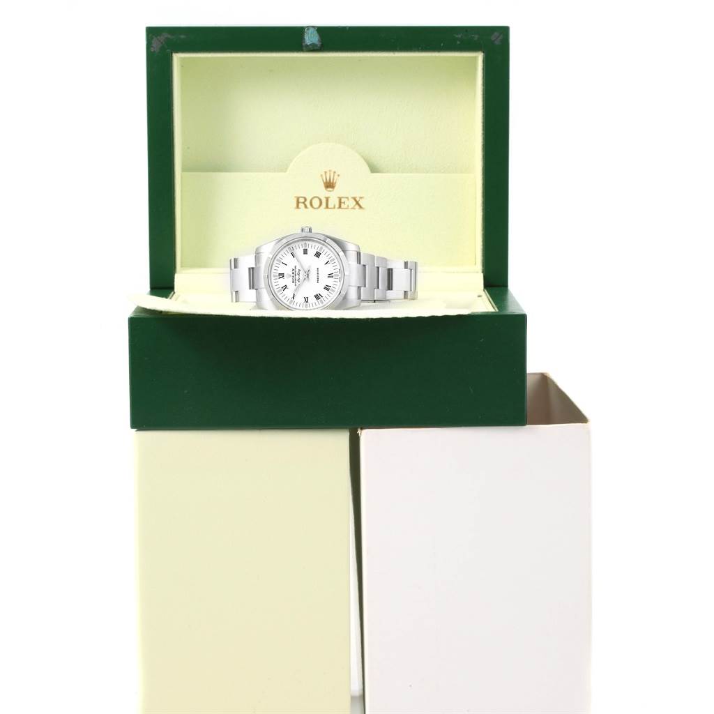 The image shows a Rolex Air-King 114210 Men's Stainless Steel White Dial 114210 Men's Stainless Steel White Dial watch placed inside its open green and beige box, viewed from the front.