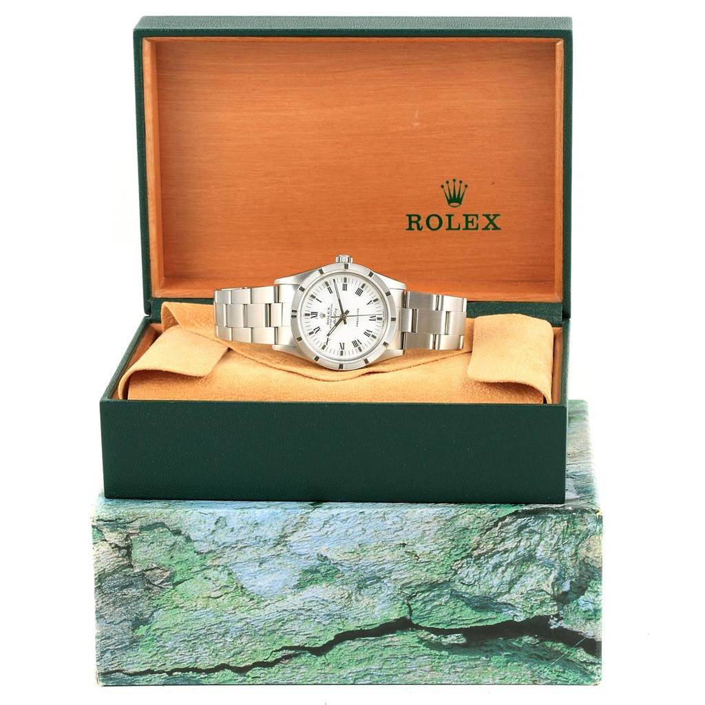 The Rolex Air-King 14010 Men's Stainless Steel White Dial 14010 Men's Stainless Steel White Dial watch is displayed at an angle in an open green and wood-tone Rolex box with its bracelet visible.