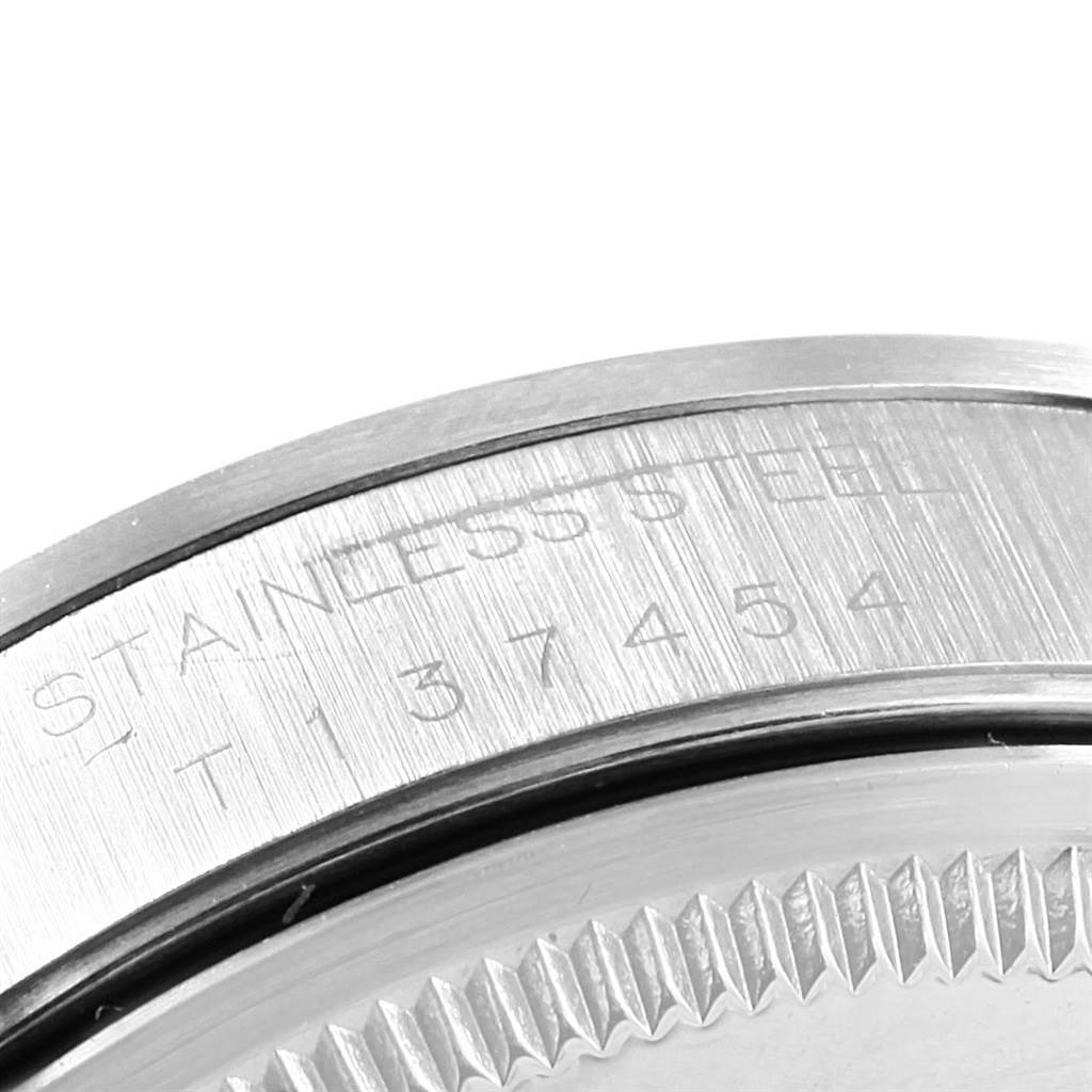 The image shows a close-up view of the case back of a Rolex Air-King 14000 Men's Stainless Steel Silver Dial 14000 Men's Stainless Steel Silver Dial watch, highlighting the serial number and "STAINLESS STEEL" engraving.