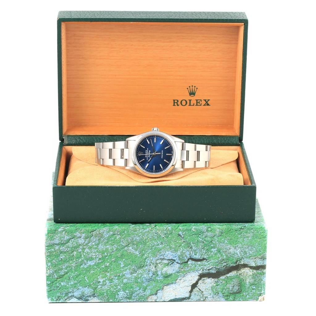 The Rolex Air-King 14000 Men's Stainless Steel Blue Dial 14000 Men's Stainless Steel Blue Dial watch is shown from the front, displayed in its open green and wood-colored box.