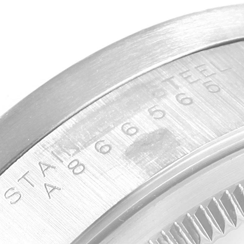 This image shows a close-up angle of the engraved case back and edge of the Air-King model by Rolex.