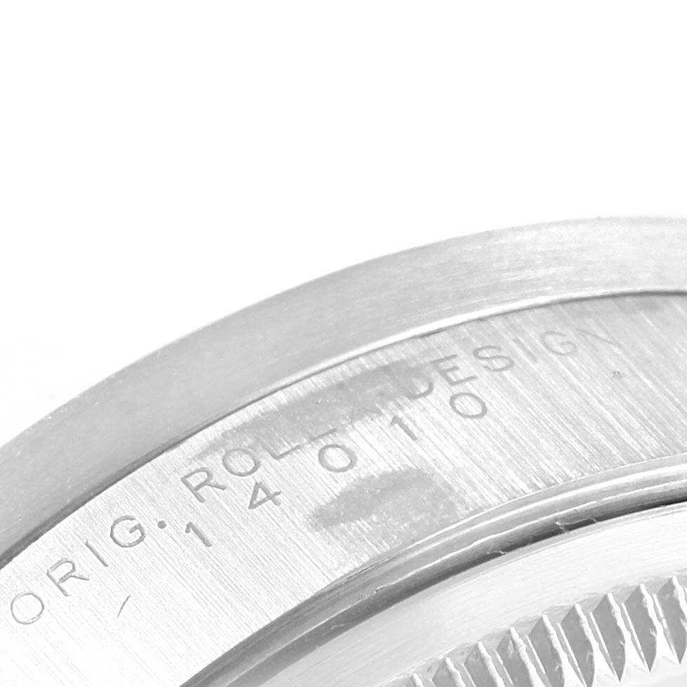 This close-up angle shows part of the casing and serial number engraving on a Rolex Air-King 14010 Stainless Steel Pink Dial 14010 Stainless Steel Pink Dial watch.