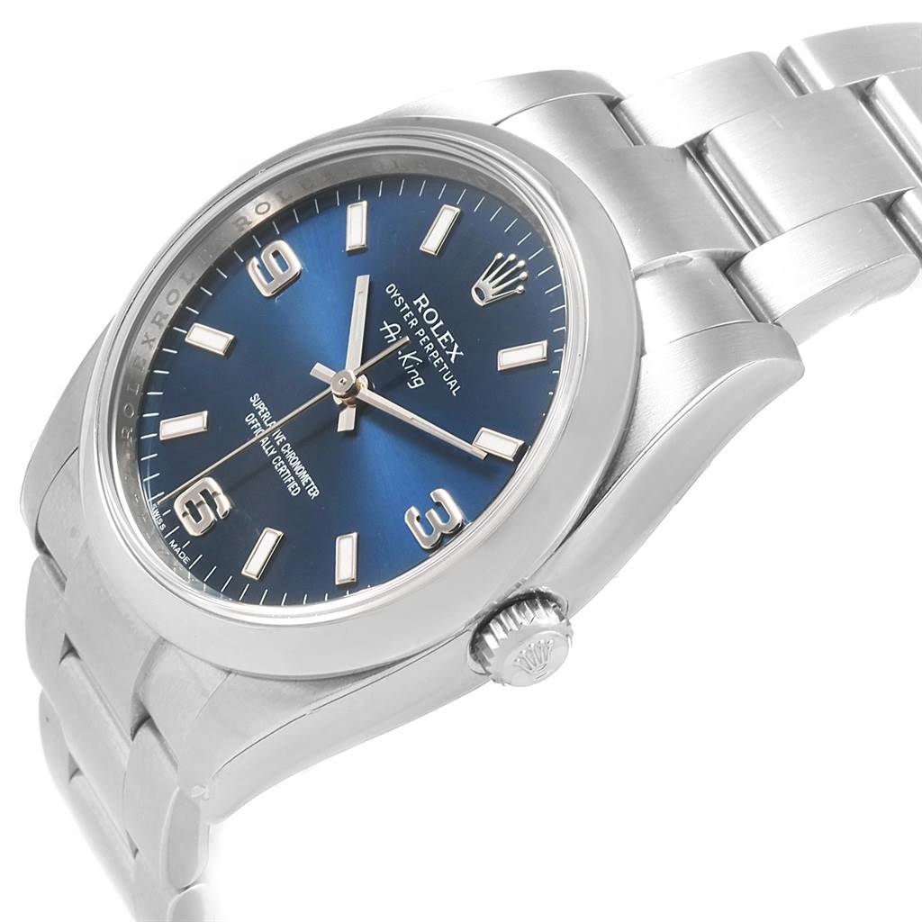 The Rolex Air-King 114200 Men's Stainless Steel Blue Dial 114200 Men's Stainless Steel Blue Dial watch is shown from an angled view highlighting its face, bezel, crown, and part of the bracelet.