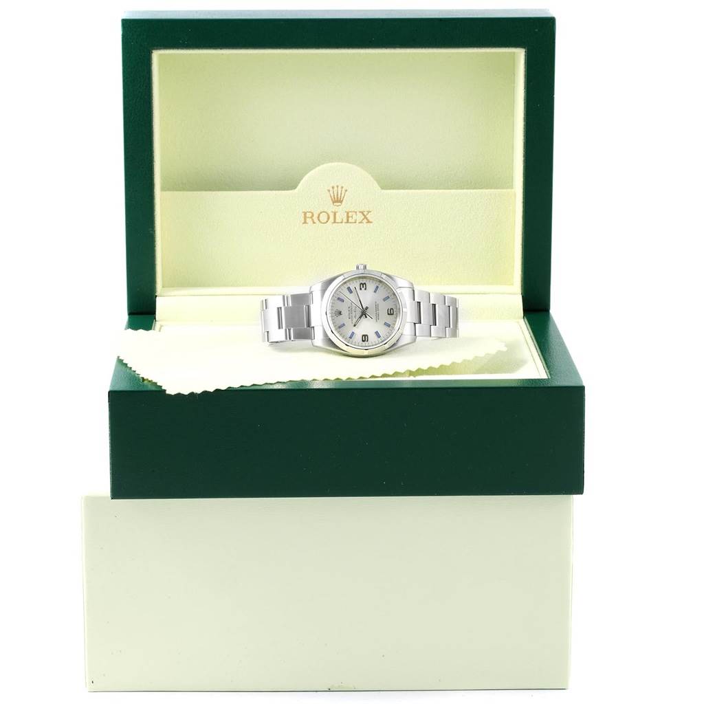 The Rolex Air-King 114210 Men's Stainless Steel Silver Dial 114210 Men's Stainless Steel Silver Dial watch is shown front-on in its open green and cream display box.