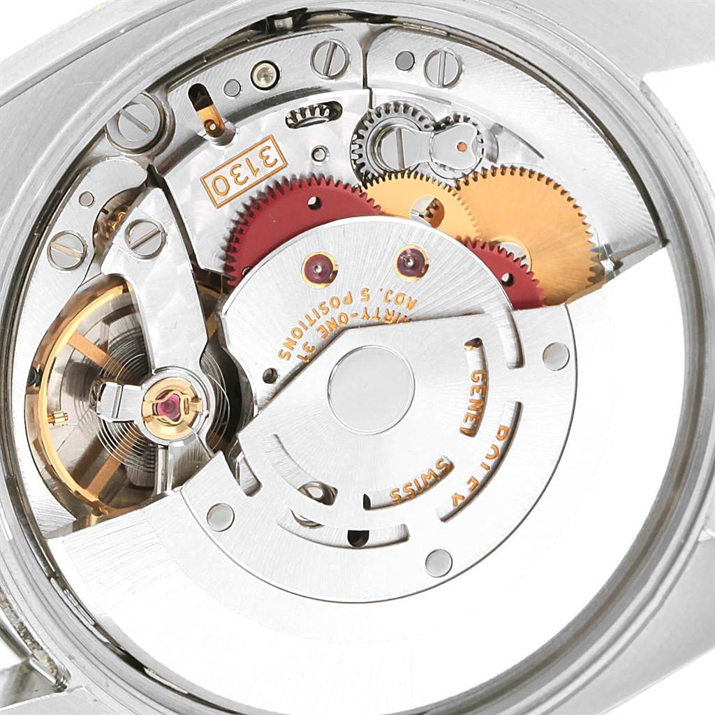 The image shows the internal movement mechanism of a Rolex Air-King 114210 Men's Stainless Steel Silver Dial 114210 Men's Stainless Steel Silver Dial watch at an angle exposing its gears and components.