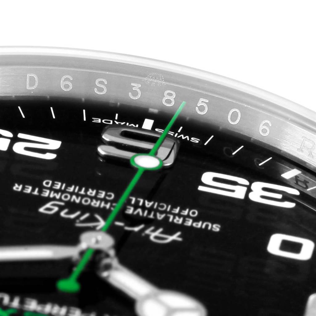 This close-up image shows the dial of a Rolex Air-King 116900 Men's Stainless Steel Black Dial 116900 Men's Stainless Steel Black Dial watch, highlighting some numerals and the green second hand.