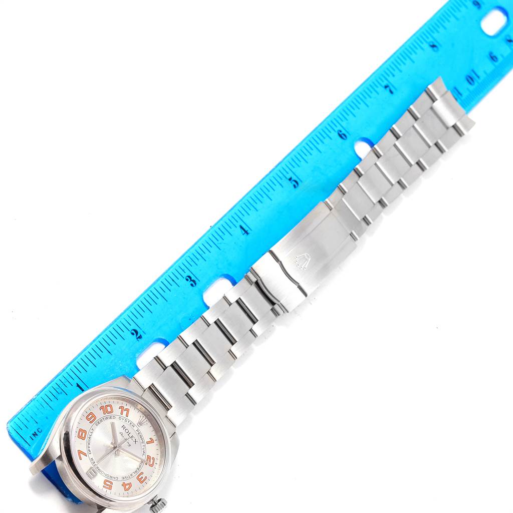 The image shows a Rolex Air-King 114200 Men's Stainless Steel Silver Dial 114200 Men's Stainless Steel Silver Dial watch laid flat alongside a ruler, displaying the watch face and stainless steel bracelet.