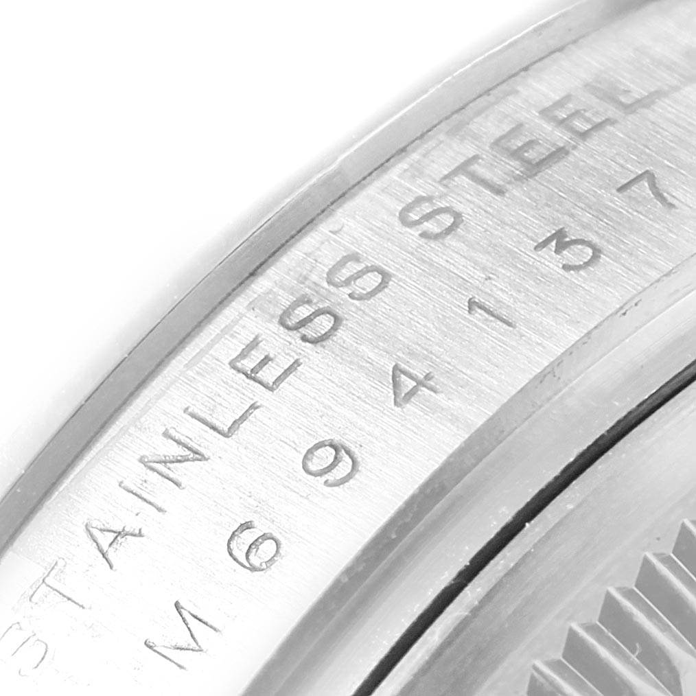 This image shows a close-up of the stainless steel casing of a Rolex Air-King 114200 Men's Stainless Steel Silver Dial 114200 Men's Stainless Steel Silver Dial watch.