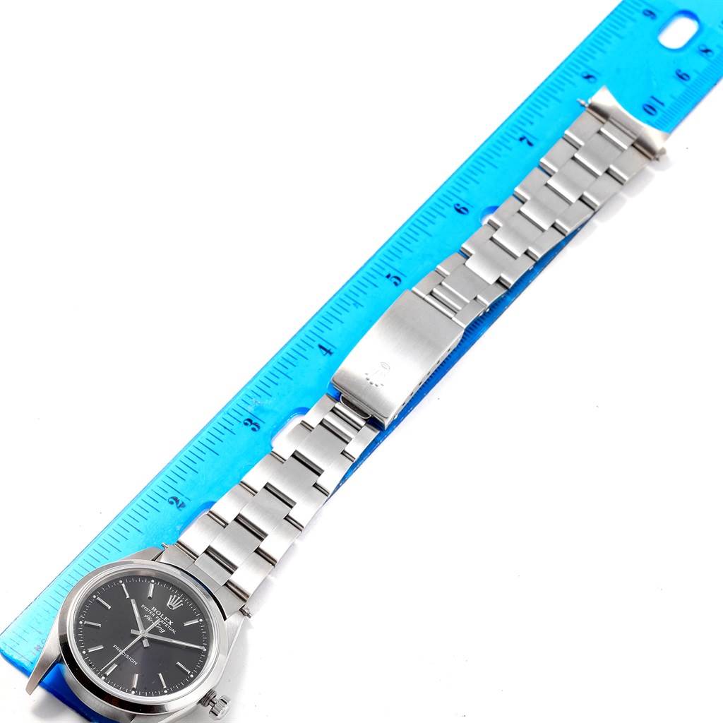 The image shows the Rolex Air-King 14000 Men's Stainless Steel Black Dial 14000 Men's Stainless Steel Black Dial watch laid flat with a ruler, showcasing the face, bracelet, and clasp from an overhead angle.