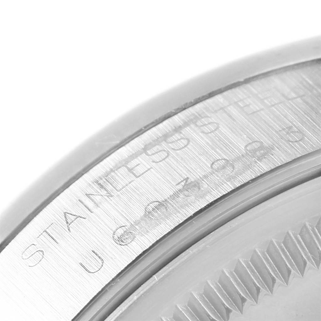 The image shows a close-up view of the case back edge of a Rolex Air-King 14000 Men's Stainless Steel Black Dial 14000 Men's Stainless Steel Black Dial, highlighting the etched "STAINLESS STEEL" text.