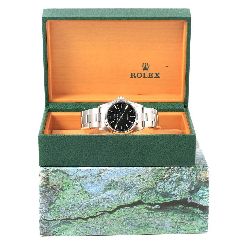 The Rolex Air-King 14000 Men's Stainless Steel Black Dial 14000 Men's Stainless Steel Black Dial watch is shown from the front and presented in its open green and orange display box.