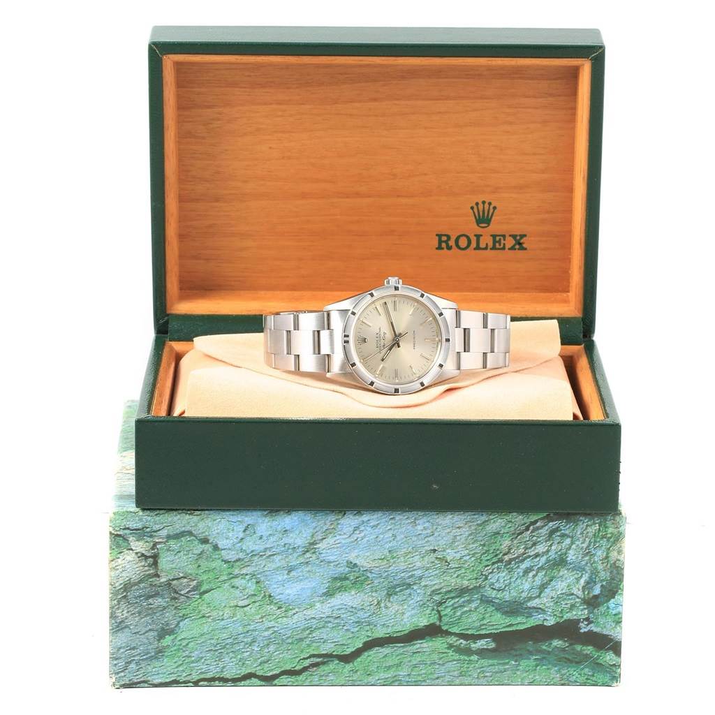 The Rolex Air-King 14010 Men's Stainless Steel Silver Dial 14010 Men's Stainless Steel Silver Dial watch is displayed front-facing inside an open green watch box with the logo visible.