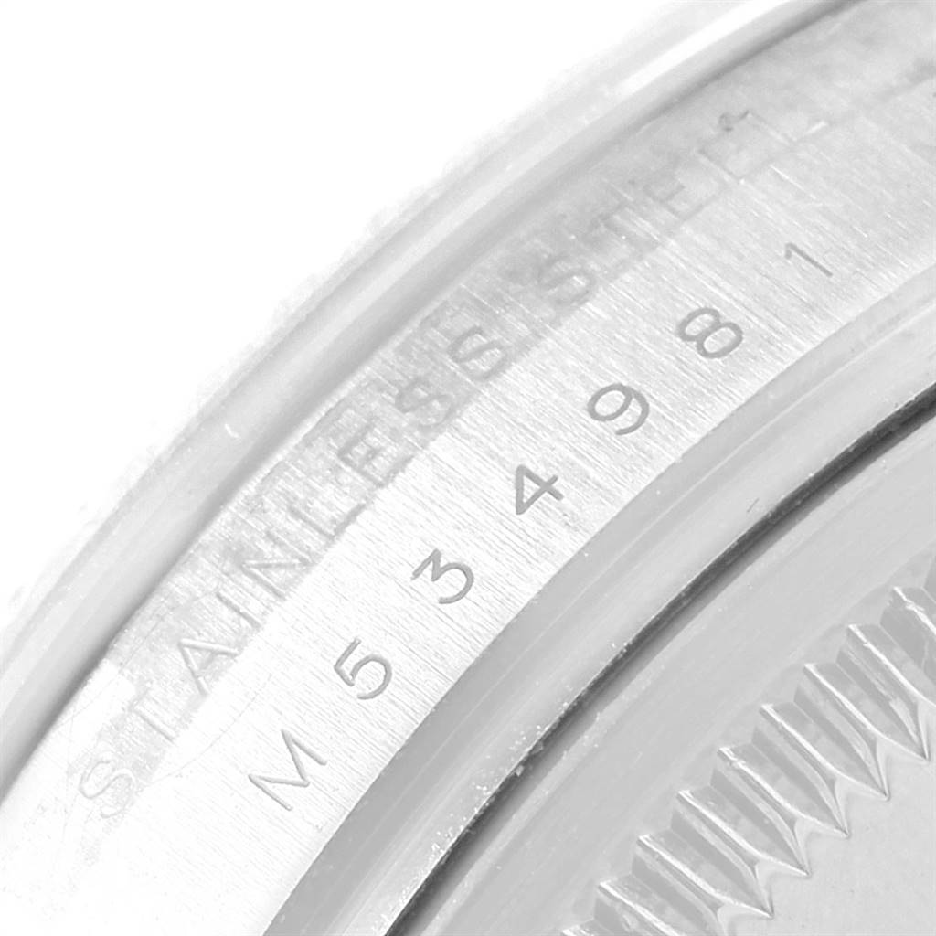 The image shows a close-up of the serialized case back of a Rolex Air-King 114234 Men's Stainless Steel Silver Dial 114234 Men's Stainless Steel Silver Dial watch, highlighting its stainless steel material and inscriptions.