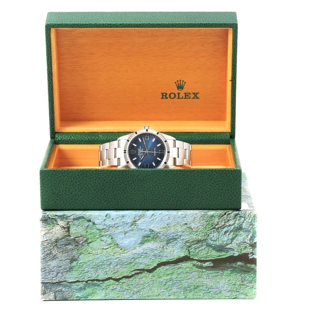 The Rolex Air-King 14010 Men's Stainless Steel Blue Dial 14010 Men's Stainless Steel Blue Dial watch is shown front-facing, displayed inside a green and wood-tone Rolex box.