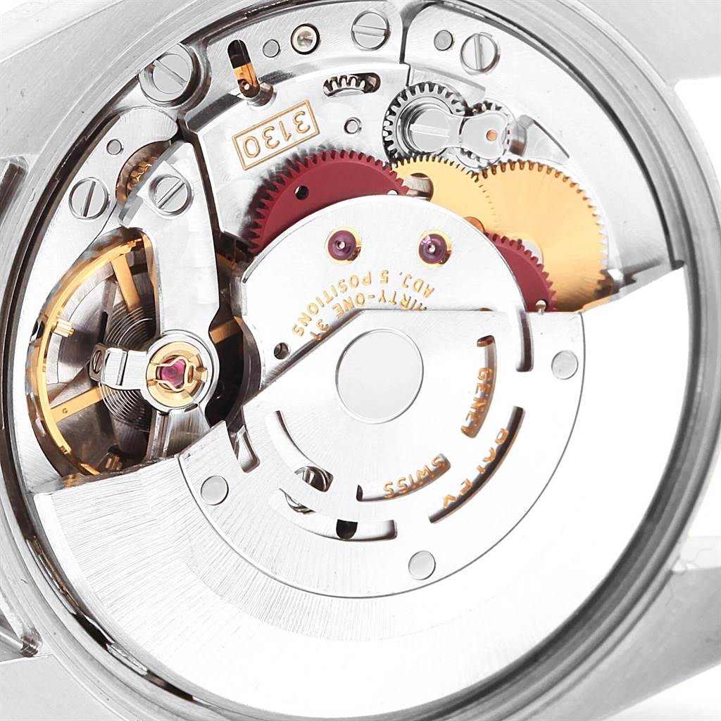 This image shows a close-up of the internal mechanism of a Rolex Air-King 114210 Men's Stainless Steel Silver Dial 114210 Men's Stainless Steel Silver Dial watch, focusing on its gears and movement components.