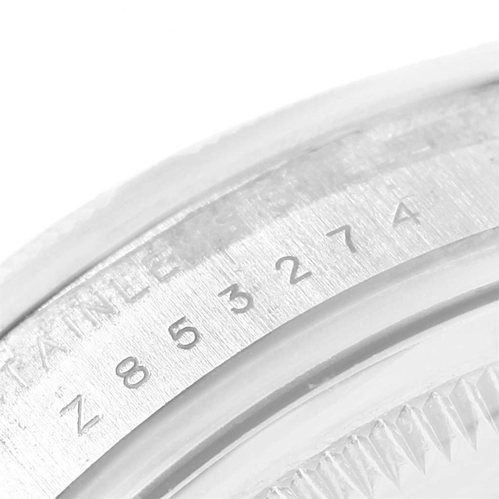 The image shows a close-up of the serial number engraved on the side of a Rolex Air-King 114210 Men's Stainless Steel Blue Dial 114210 Men's Stainless Steel Blue Dial watch case.