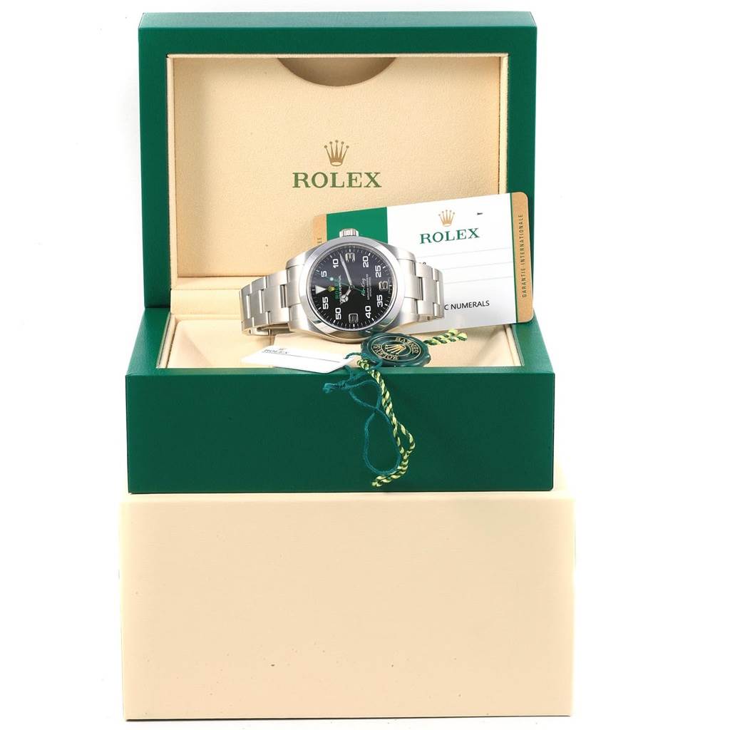 The image shows a Rolex Air-King 116900 Men's Stainless Steel Black Dial 116900 Men's Stainless Steel Black Dial watch at a slight angle, inside its open green box along with the warranty card and tags.