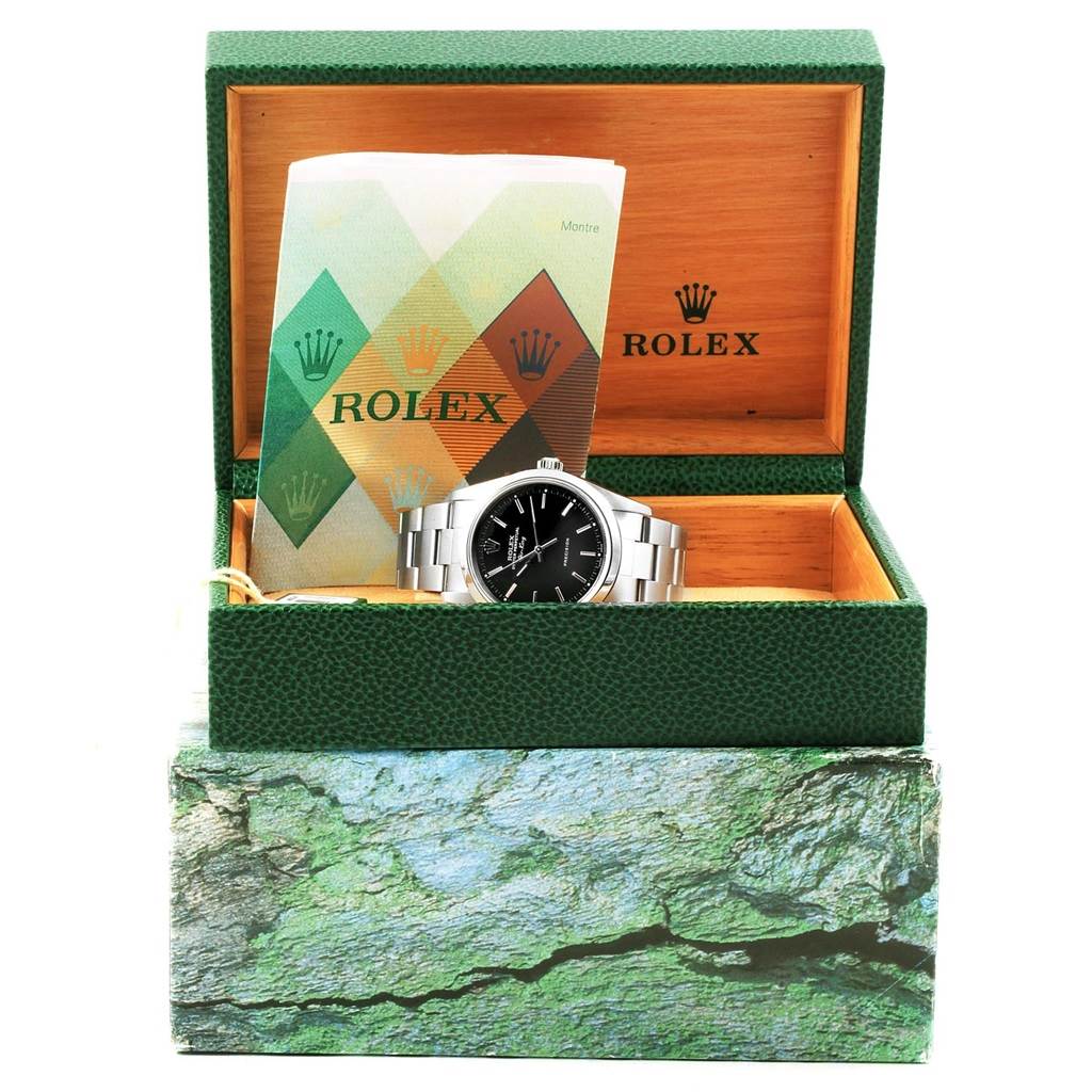The Rolex Air-King 14000 Men's Stainless Steel Black Dial 14000 Men's Stainless Steel Black Dial watch is shown front-facing in its open green box with accompanying documents.