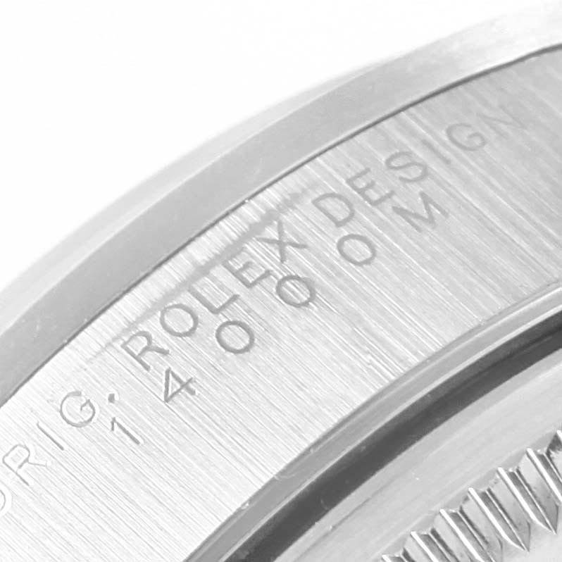 The image shows a close-up of the side and partial back of the Air-King model by Rolex, highlighting engraved text and the case edge.