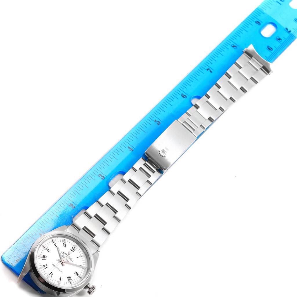 The image shows a Rolex Air-King 14000 Men's Stainless Steel White Dial 14000 Men's Stainless Steel White Dial watch photographed flat with its metal bracelet aligned next to a blue ruler.