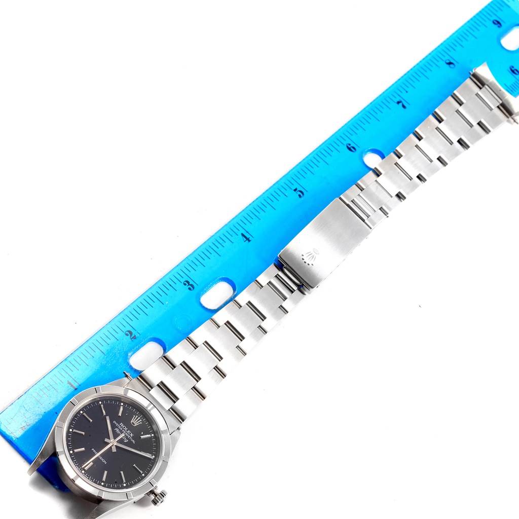 The image shows a Rolex Air-King 14010 Men's Stainless Steel Black Dial 14010 Men's Stainless Steel Black Dial watch laid flat next to a ruler, displaying the face, band, and clasp.