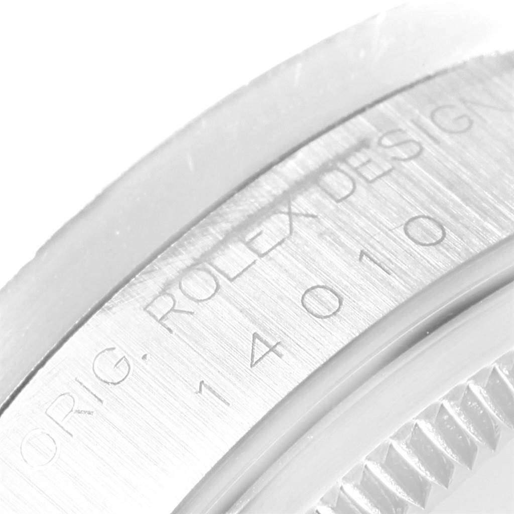 This close-up angle of the Rolex Air-King 14010 Men's Stainless Steel Black Dial 14010 Men's Stainless Steel Black Dial watch shows part of the bezel with engraved text.