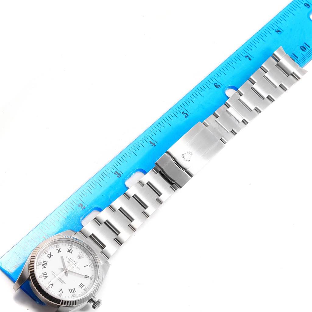 The image shows a Rolex Air-King 114234 Men's Stainless Steel White Dial 114234 Men's Stainless Steel White Dial watch laid flat with a blue ruler above the stainless steel bracelet.