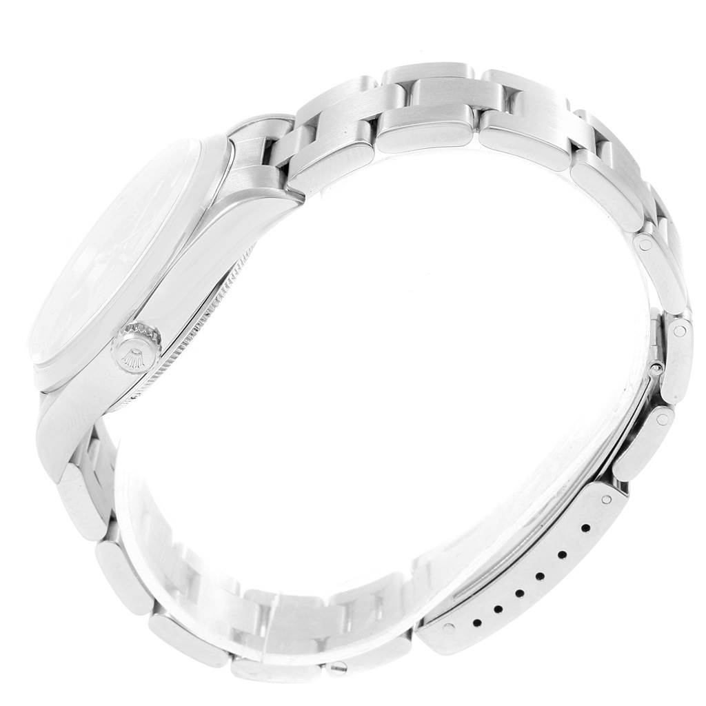 This side view of the Rolex Air-King 14000 Men's Stainless Steel Blue Dial 14000 Men's Stainless Steel Blue Dial watch showcases its crown, bezel, and stainless steel bracelet.