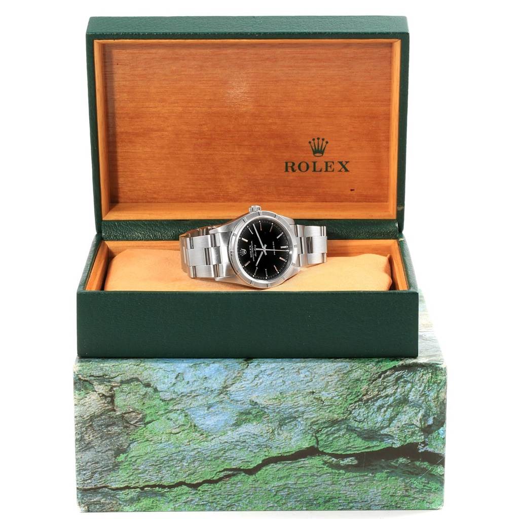The Rolex Air-King 14010 Men's Stainless Steel Black Dial 14010 Men's Stainless Steel Black Dial watch is shown in an open green and wooden box, front view with its bracelet and dial visible.