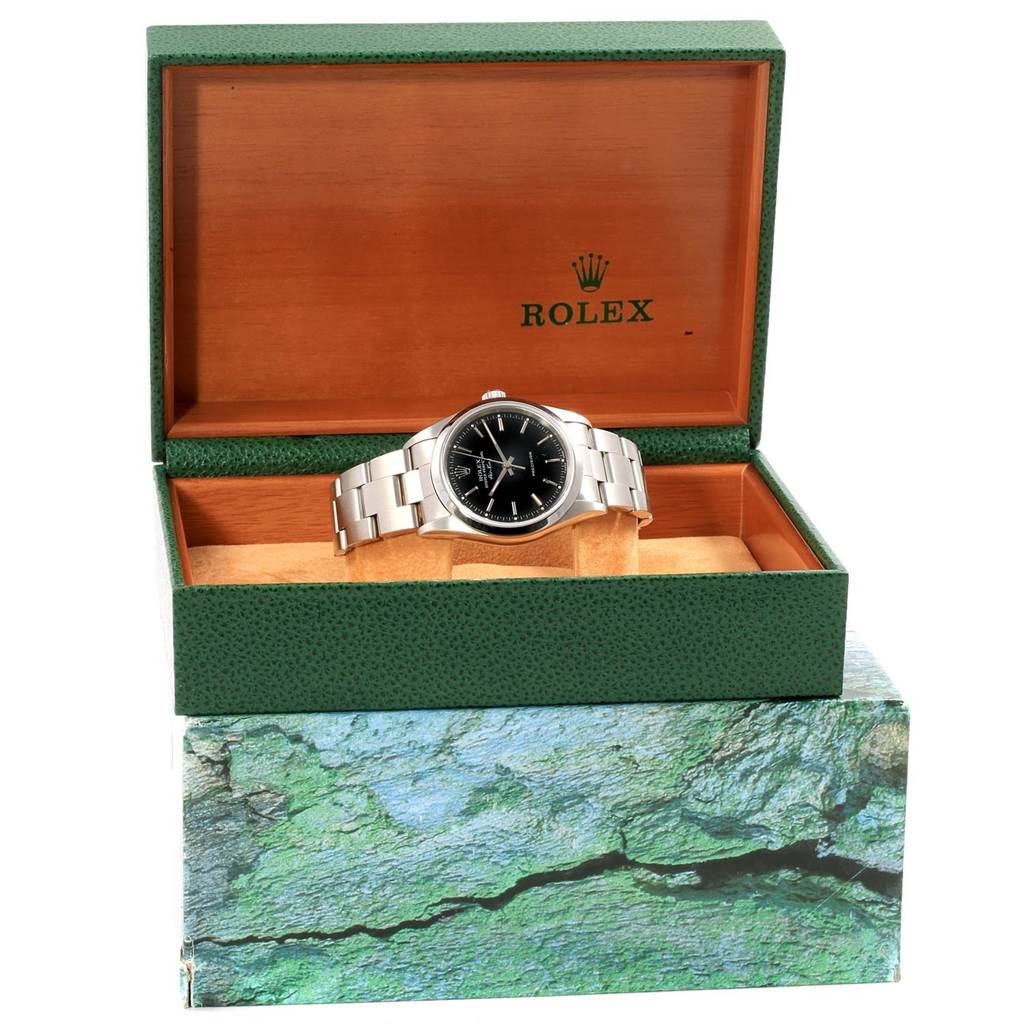 The Rolex Air-King 14000 Men's Stainless Steel Black Dial 14000 Men's Stainless Steel Black Dial watch is displayed in an open, green, and wooden box, showing the bracelet and watch face fully.