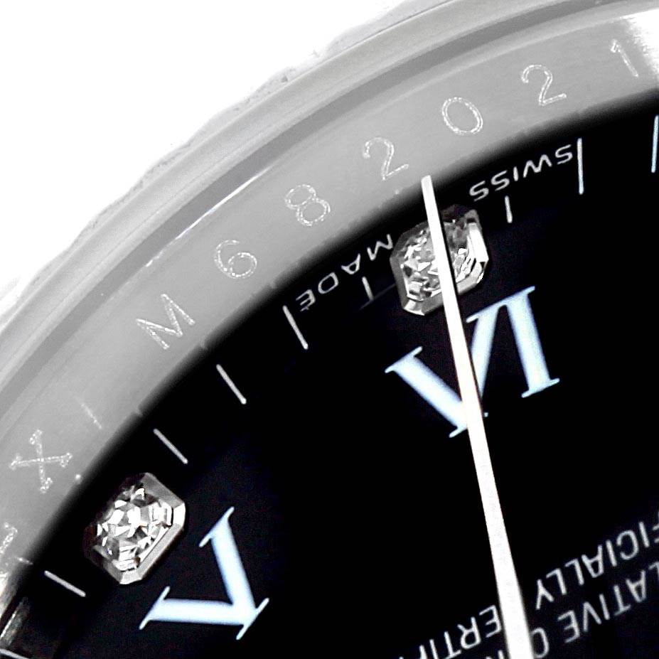 This close-up image of a Rolex Air-King 114234 Men's Stainless Steel Black Dial 114234 Men's Stainless Steel Black Dial watch shows part of the dial, Roman numerals, and diamond hour markers.