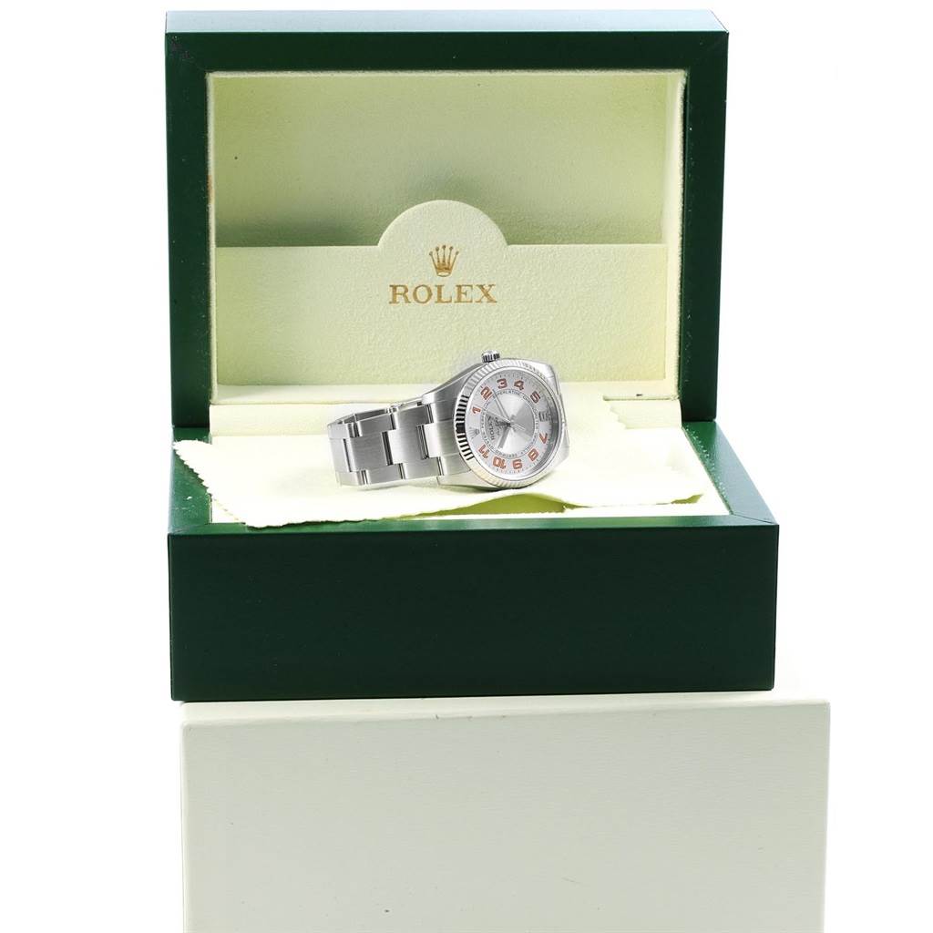 The Rolex Air-King 114234 Men's Stainless Steel Silver Dial 114234 Men's Stainless Steel Silver Dial watch is shown from the front, resting in an open green Rolex box.